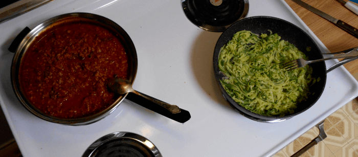 photograph of spaghetti sauce and noodles cooking on stove top, used as a header image