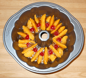 peach upside-down cake pan prepared for batter