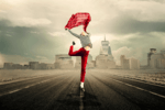 lady in red slacks dancing in the street