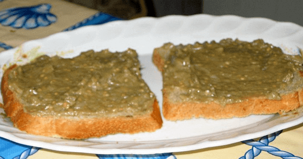 2 slices of bread with a green bread spread on them